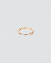 Gold White Diamond Bar Baguette Band on light color background.