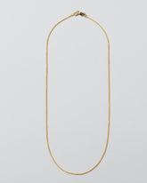 Cycle Chain Necklace on light color background.