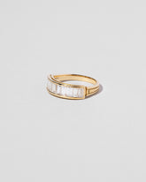View from the side of the Gold Arcade Ring on light color background.