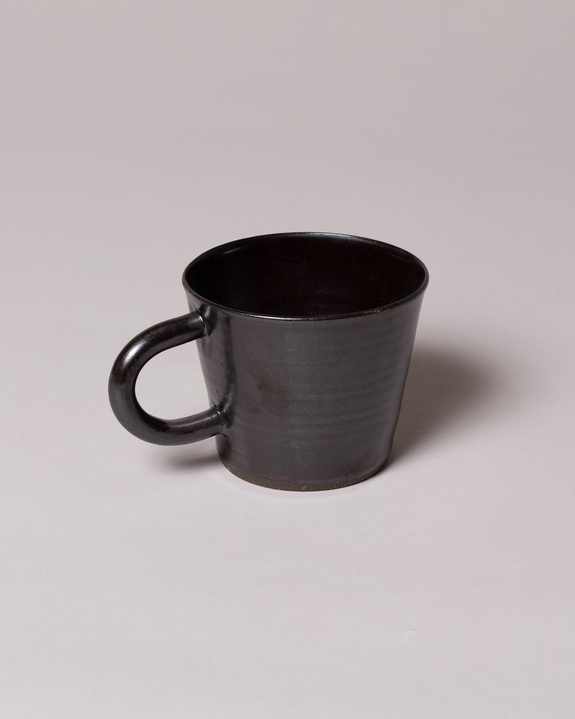 View from the back of the Eric Bonnin Gunmetal Kam Mug on light color background.