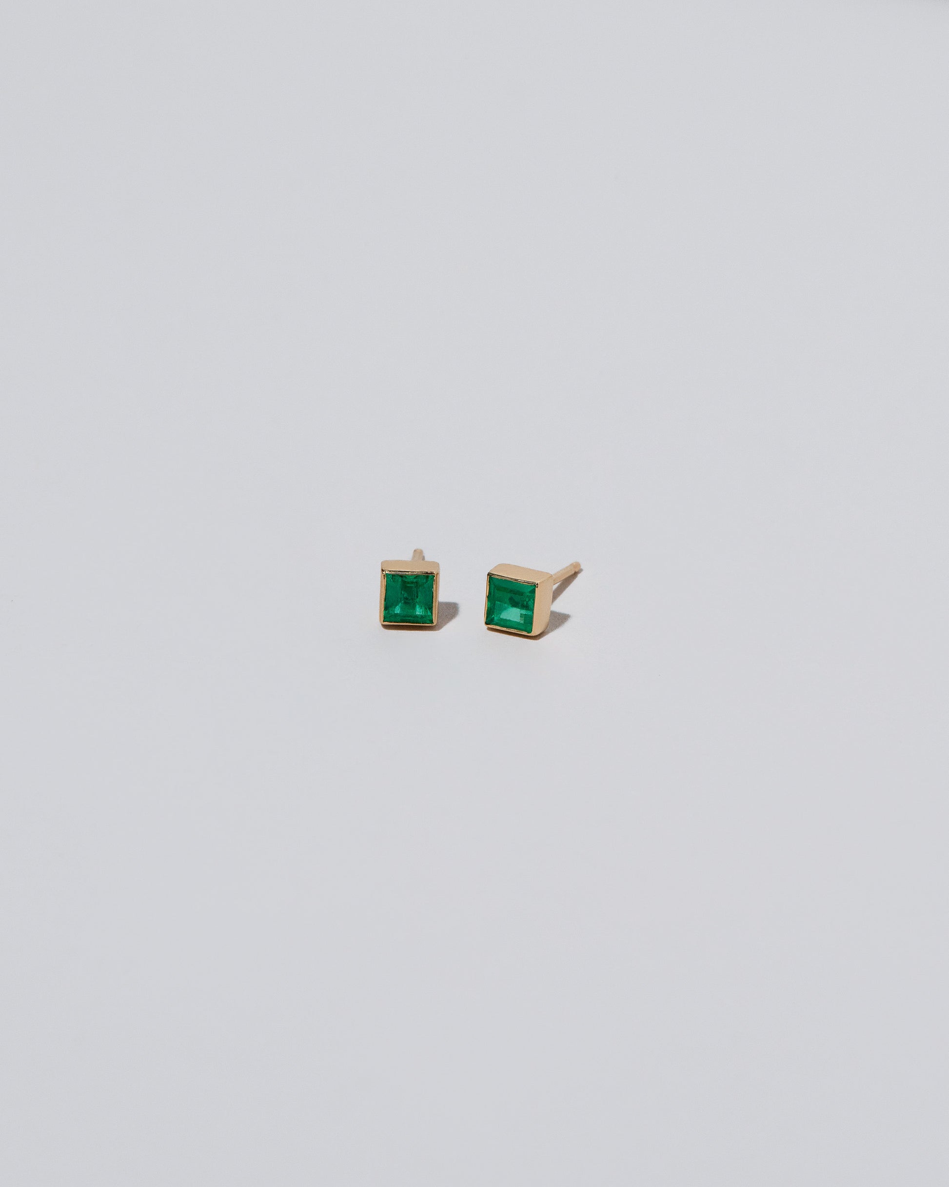 Square Stud - Emerald on light color background.