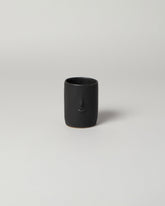 Rami Kim Black Mini Face Tumbler on light color background.