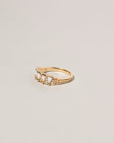 Five Triangle Ring - White Opal on light color background.