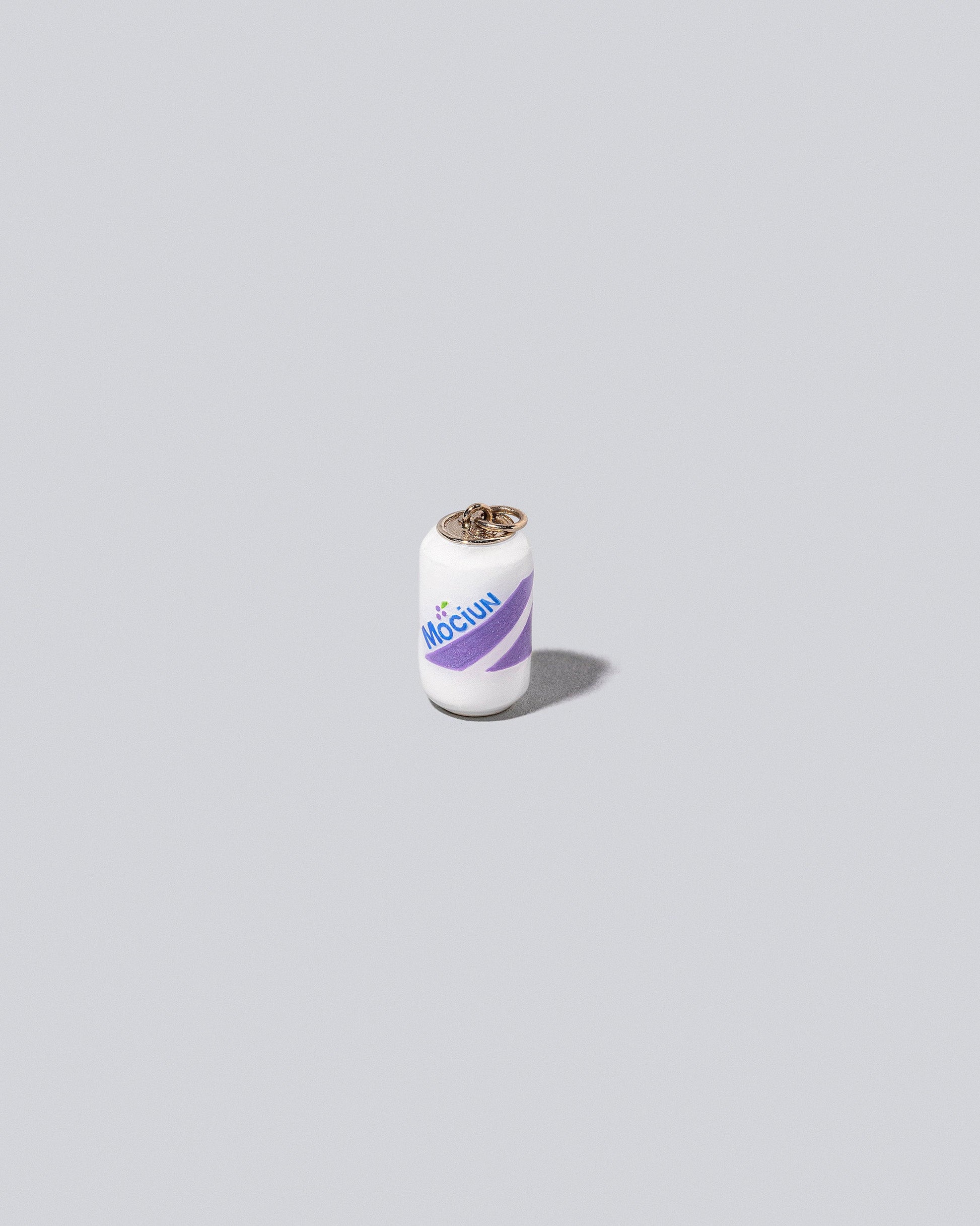 Mociun Soda Charm on light color background.