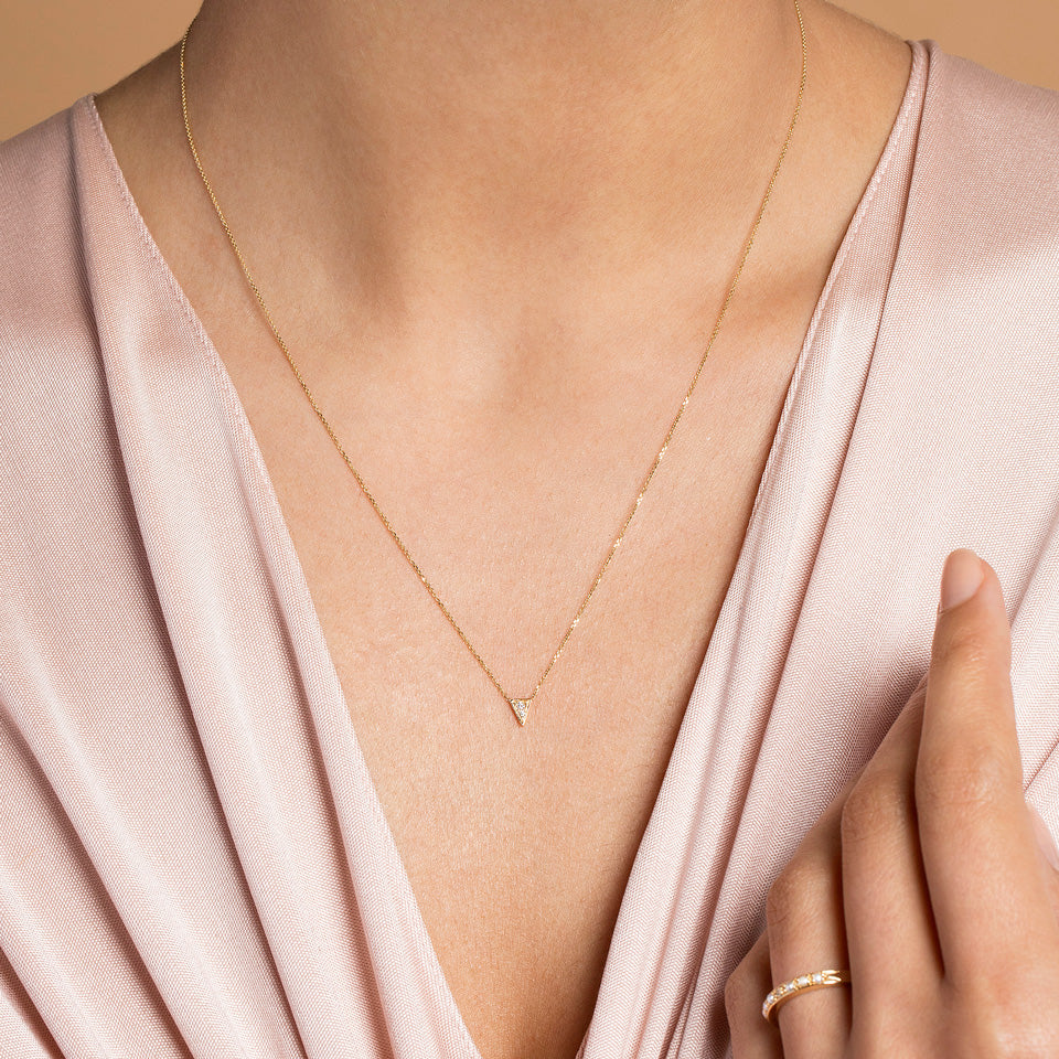 product_details::Gold White Diamond Triangle Necklace on model.