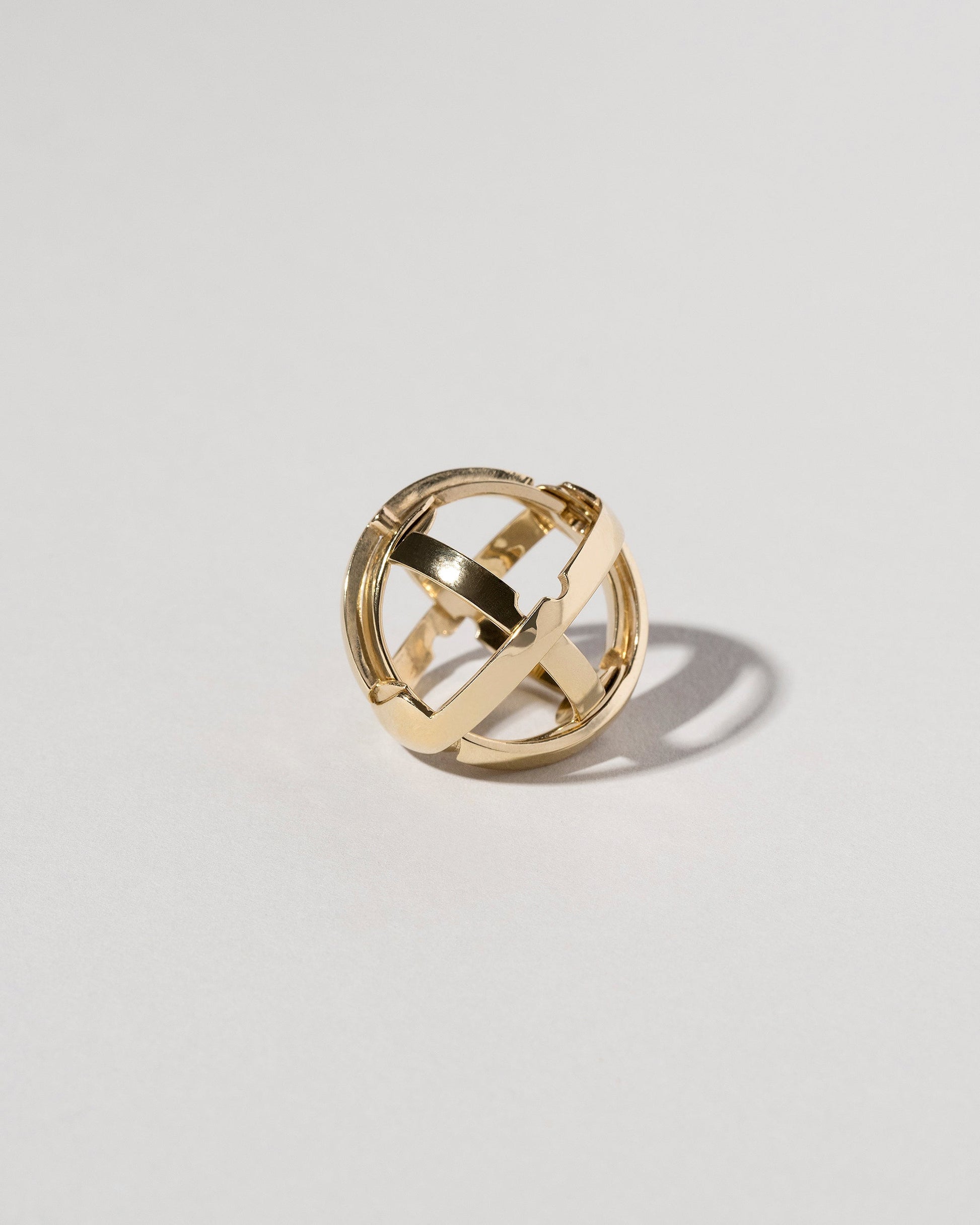 Detail view of the Armillary Sphere Band on light color background.