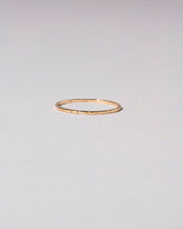 Gold 1.5mm Etched Lines Band on light color background.