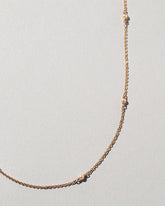 Natural Pink Seed Pearl Necklace on light color background.