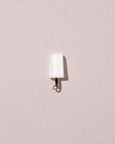 Coconut Popsicle Charm on light color background.