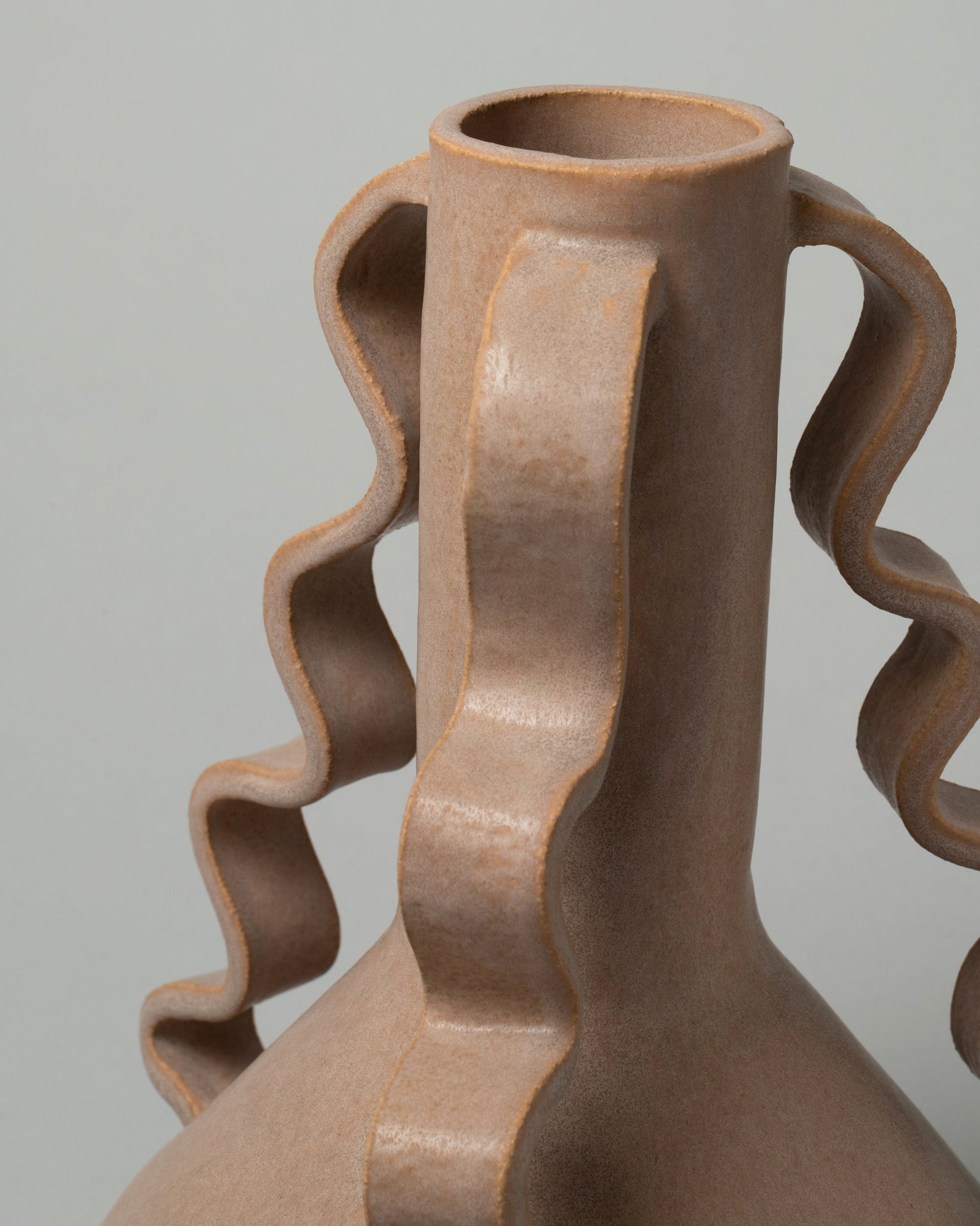 Detail view of Morgan Peck Mauve Swoop Vase on light color background.