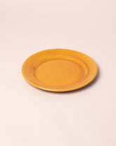 Closeup details of the La Ceramica Vincenzo Del Monaco Caramel Yellow Large Dish on light color background.