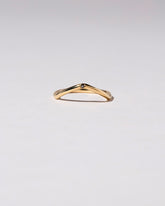 Gold Single Stone Black Diamond Low Peak Band on light color background.
