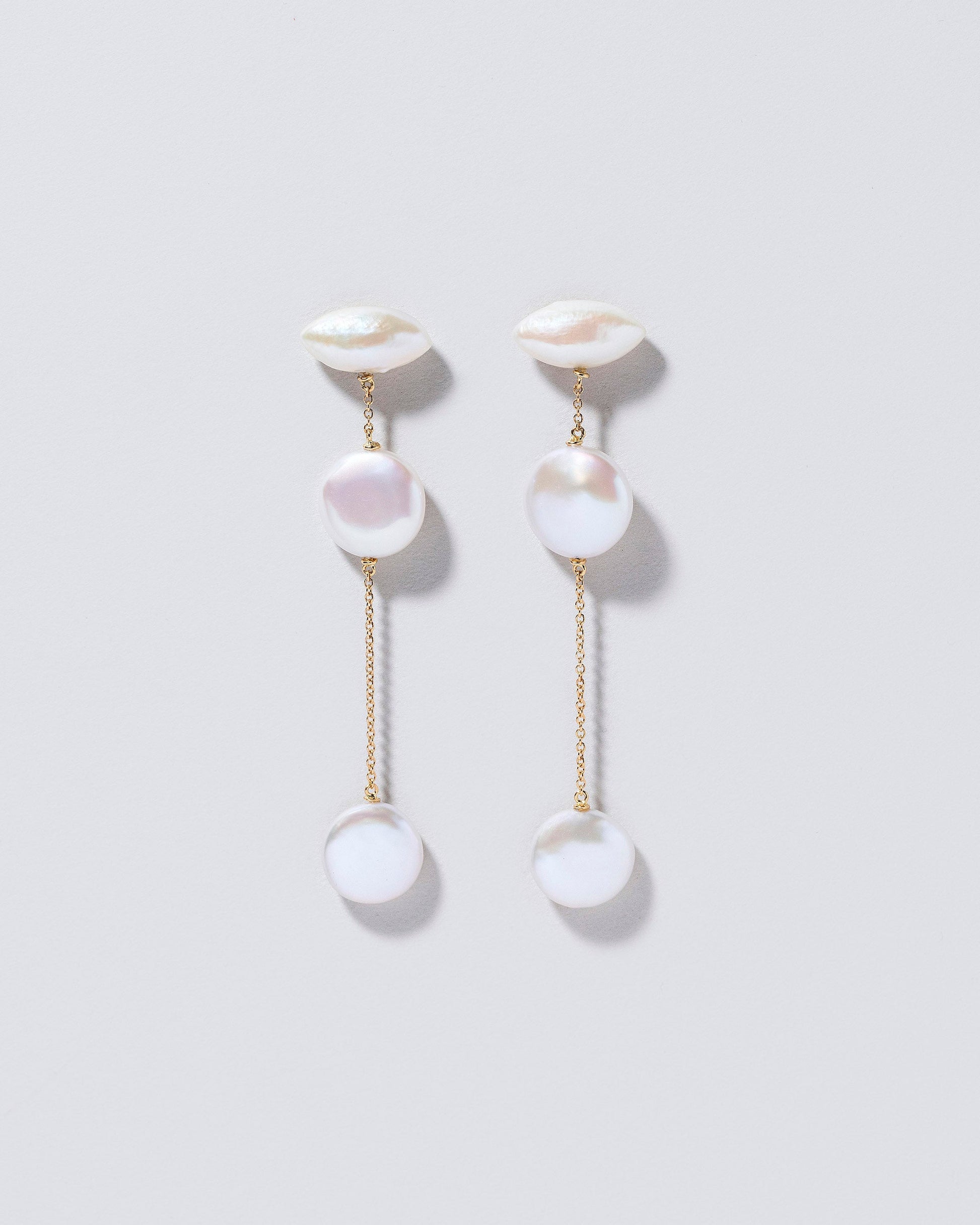 Idas Earrings on light color background.