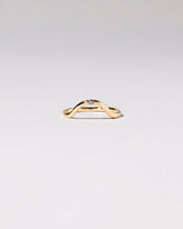 Gold Single Stone Blue Sapphire Curve Band on light color background.