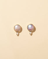 Mabe Pearl & Diamond Earrings on light color background.