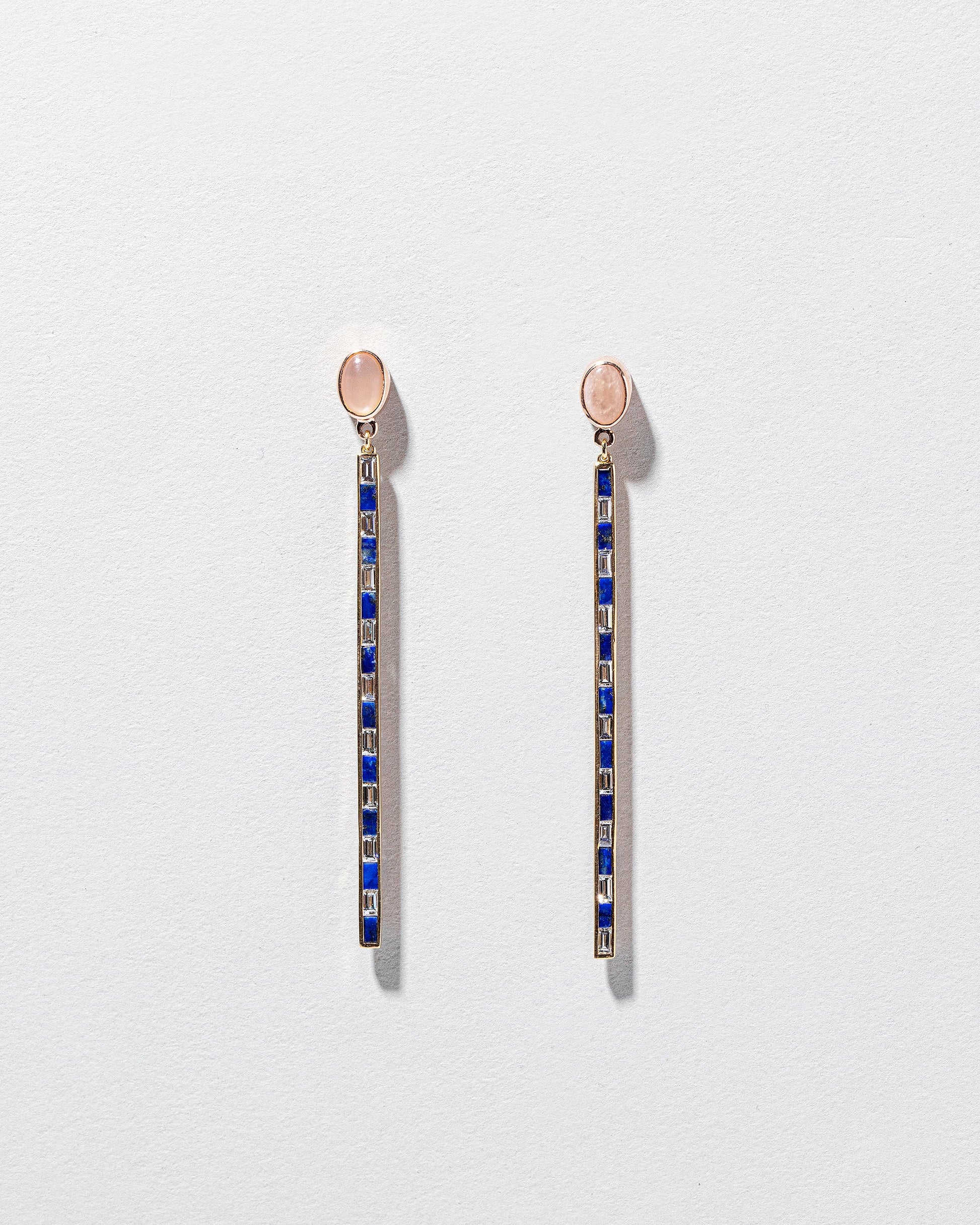 Peach Moonstone Transformation Earrings on light color background.