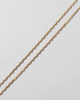 Petite Diamond Cut Chain Necklace on light color background.