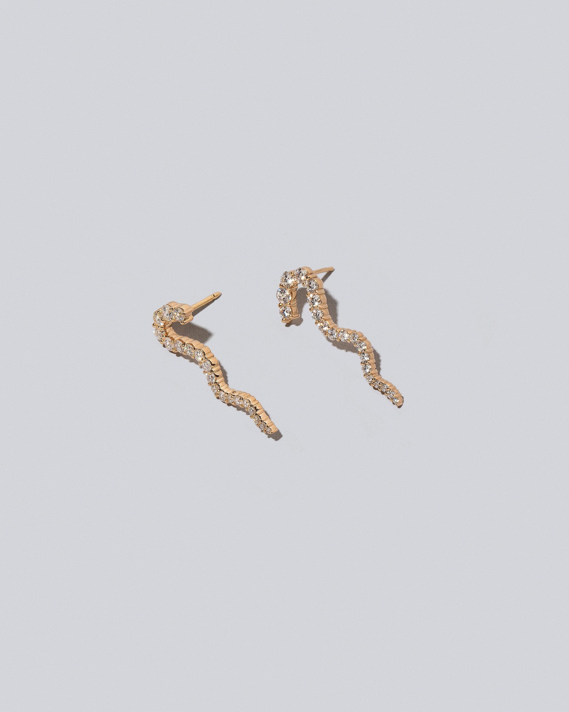 Ripple Wave Single Earrings on light color background.