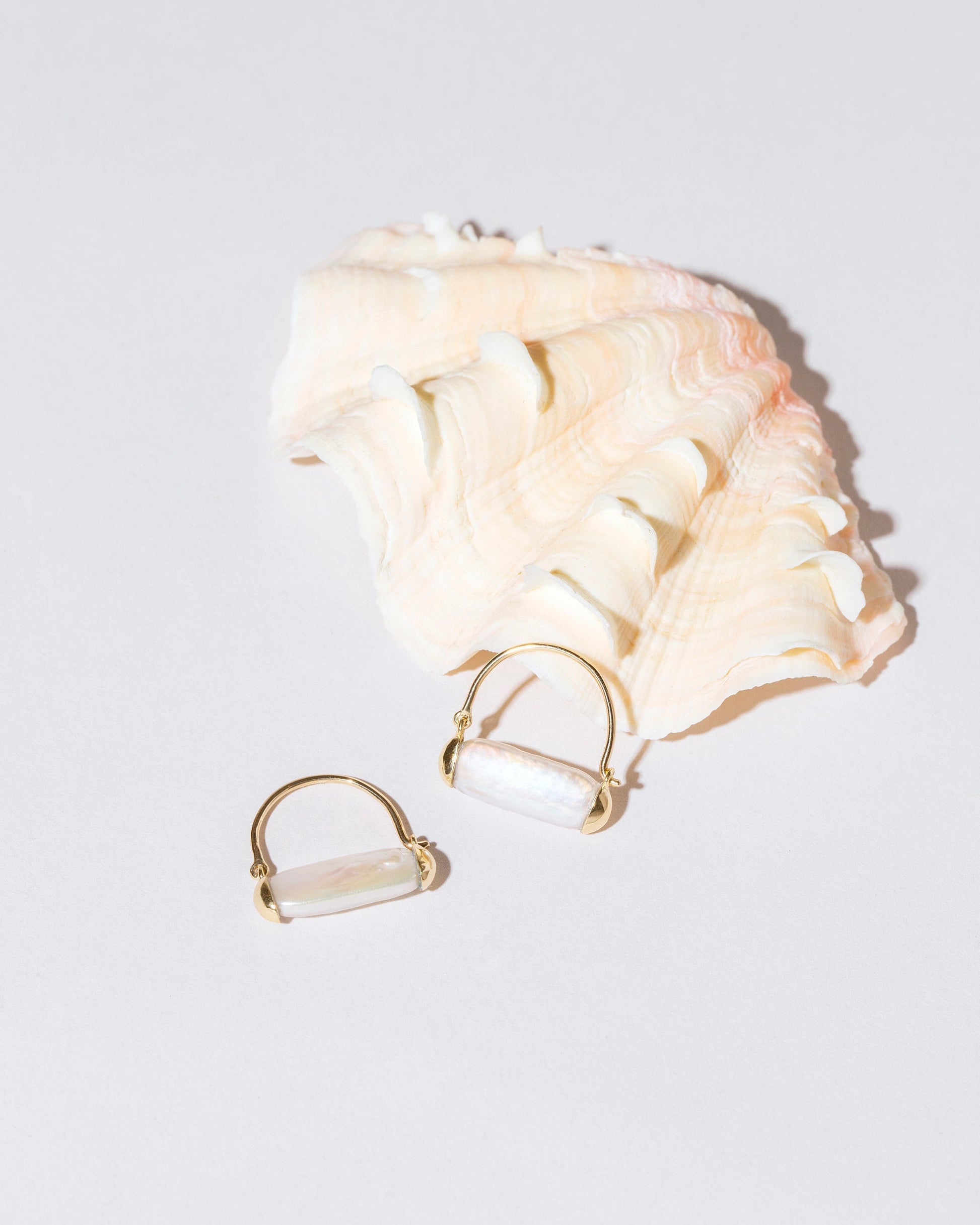 Pearl Hoop Earrings on light color background.