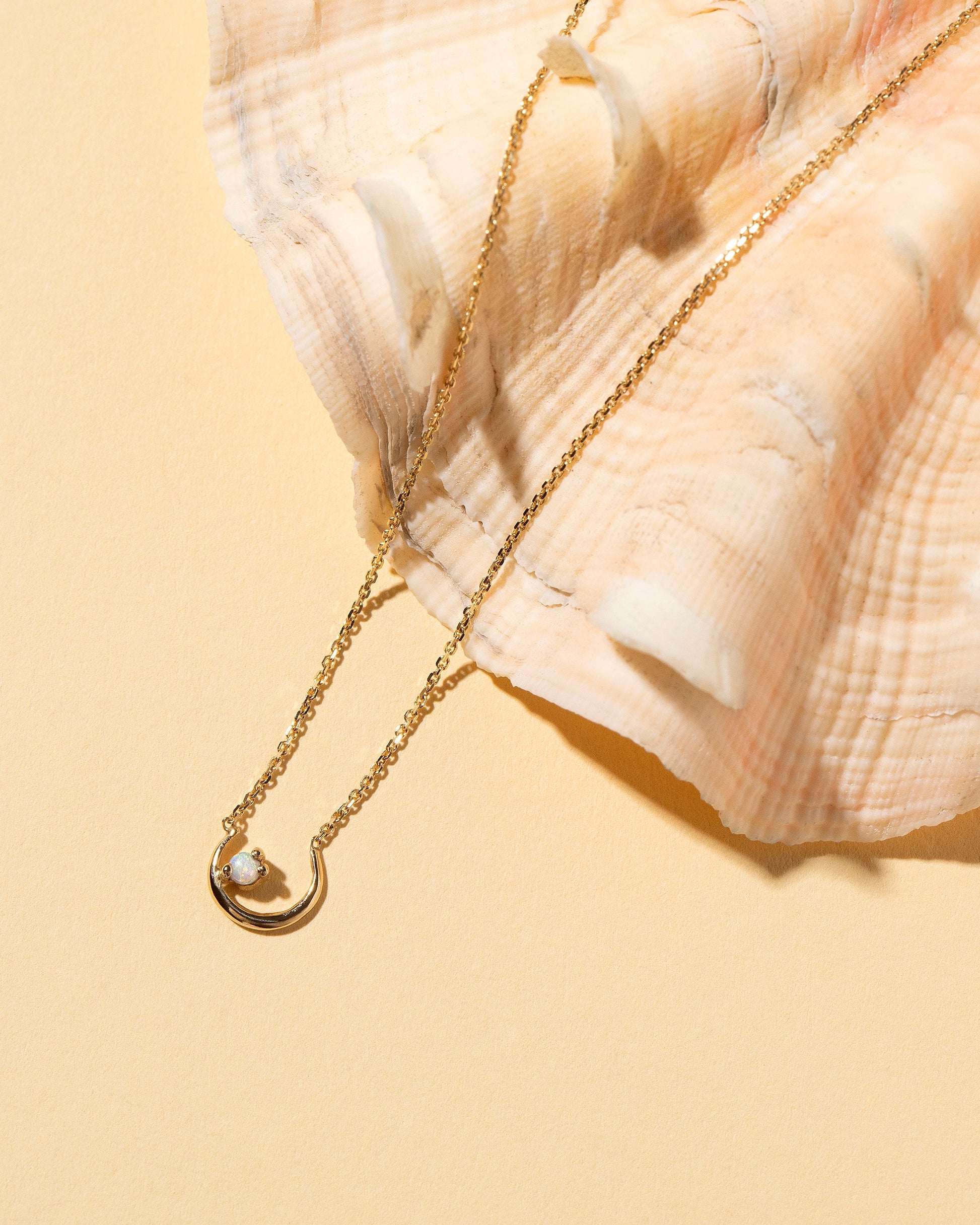 Moon Ray Necklace on light color background.