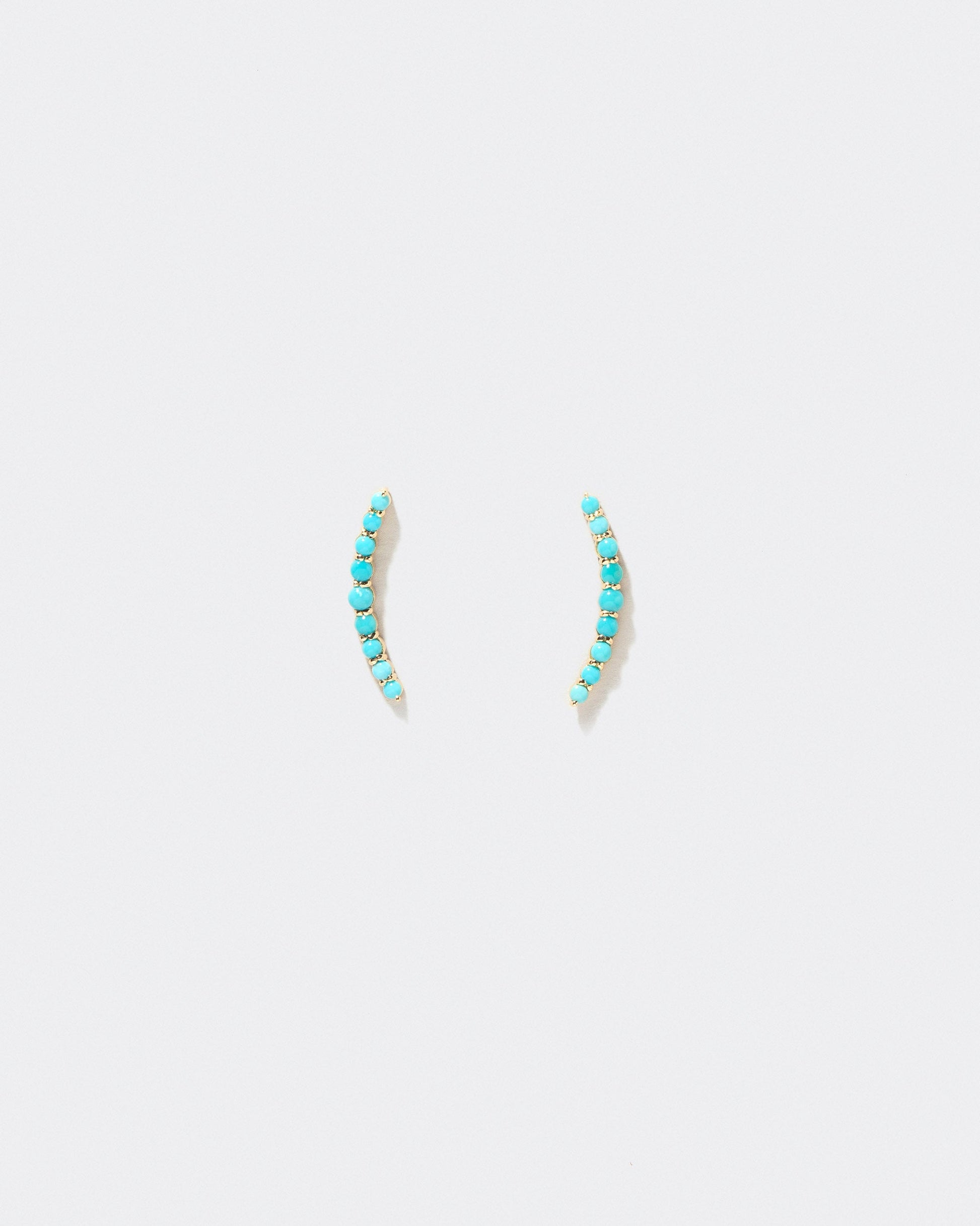 Crescent Ear Climber Stud Earrings - Turquoise on a light background.