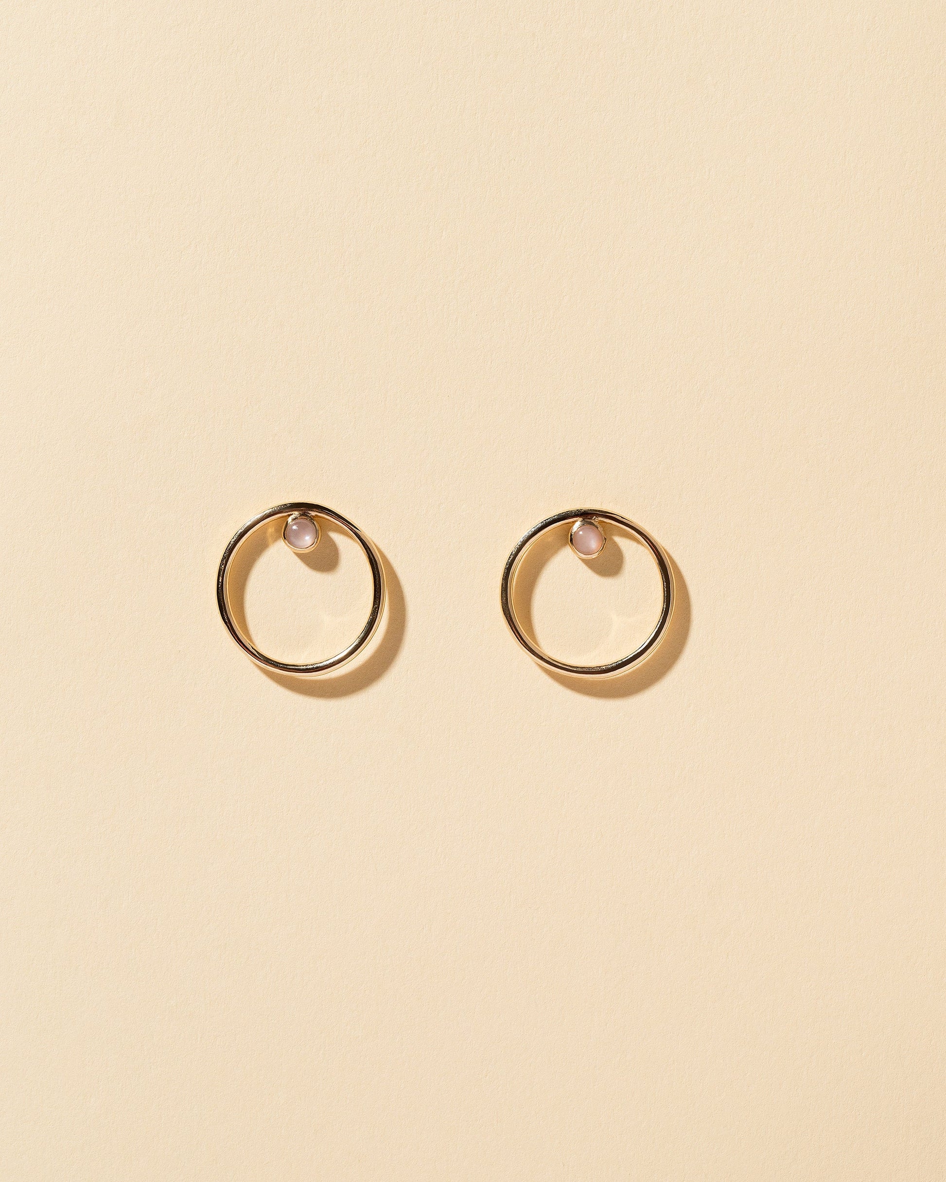  Coil Stud Earrings on light color background.