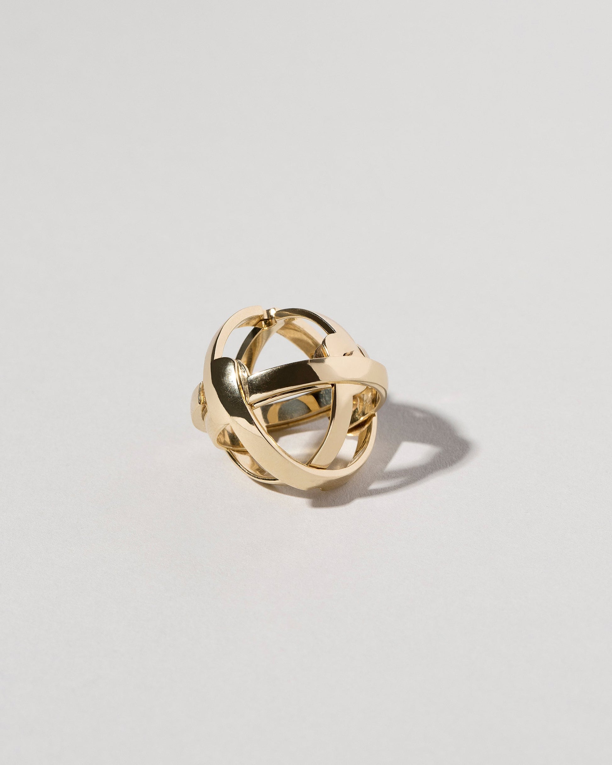 Detail view of the Armillary Sphere Band on light color background.