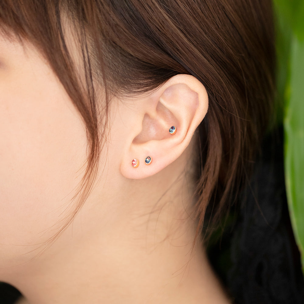 product_details::Oval Frame Stud Earrings on model.