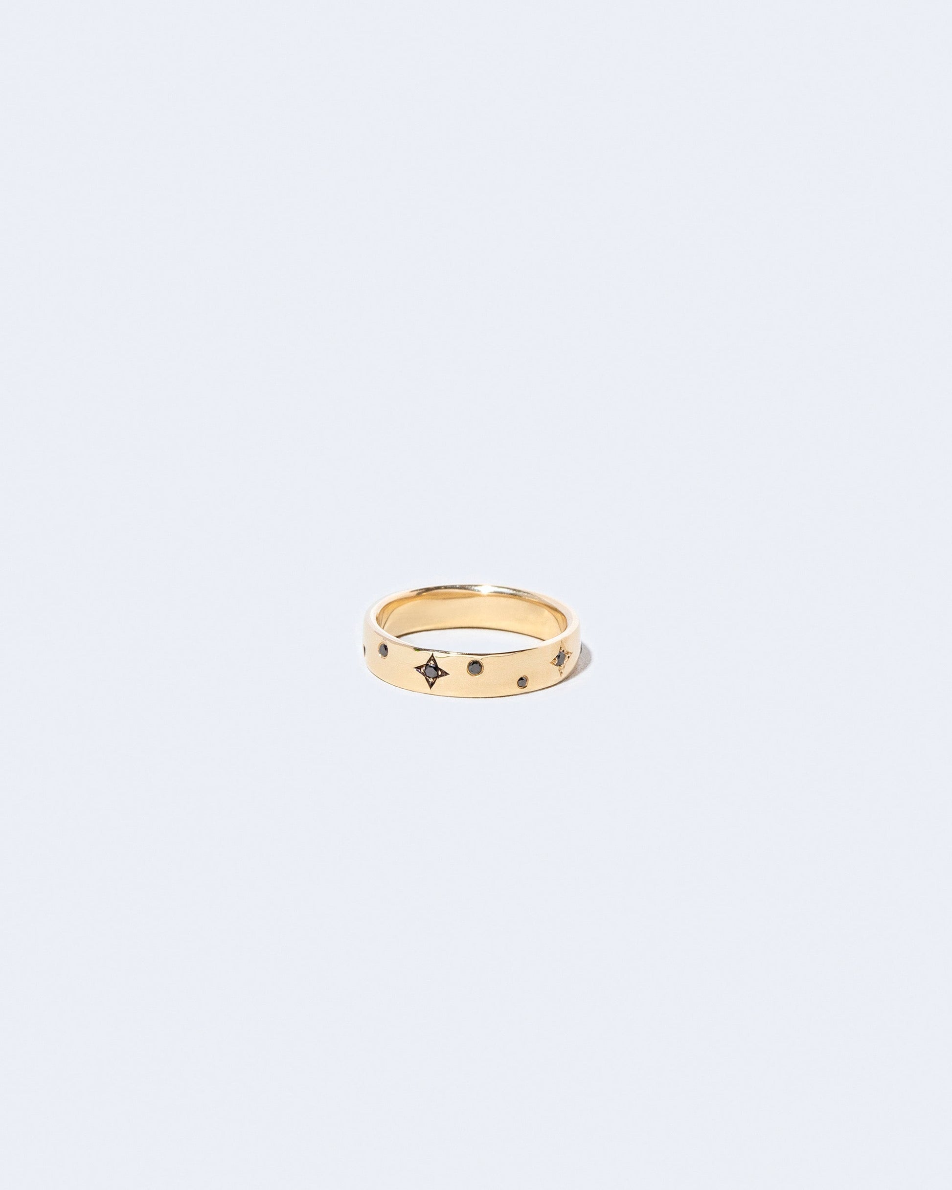 Gold 4mm Square Wire Band with Little Array Black Diamonds added on light color background.