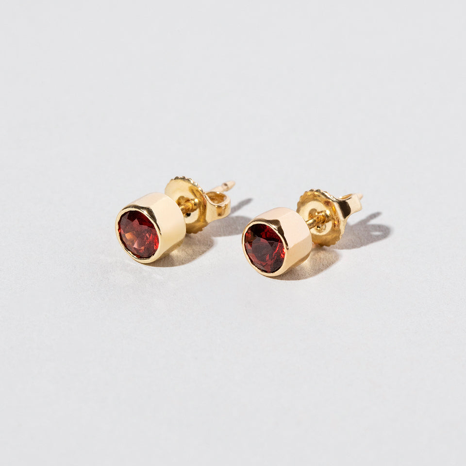 product_details:: Garnet Studs on light color background.