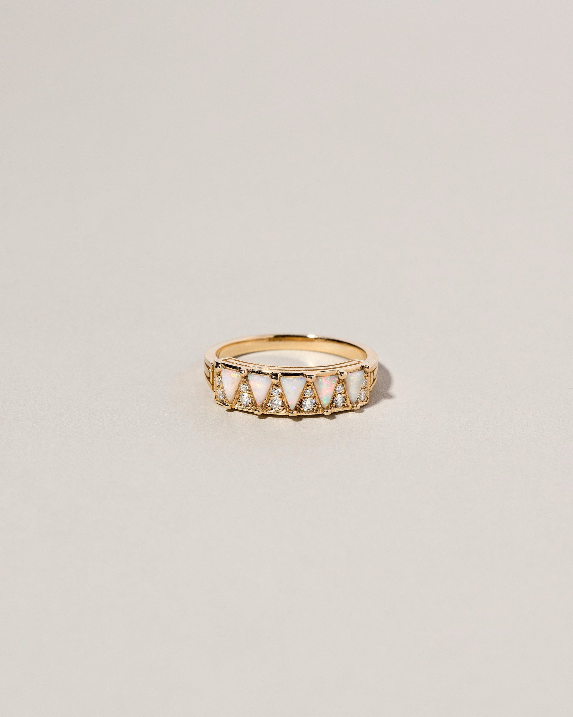 Five Triangle Ring - White Opal on light color background.