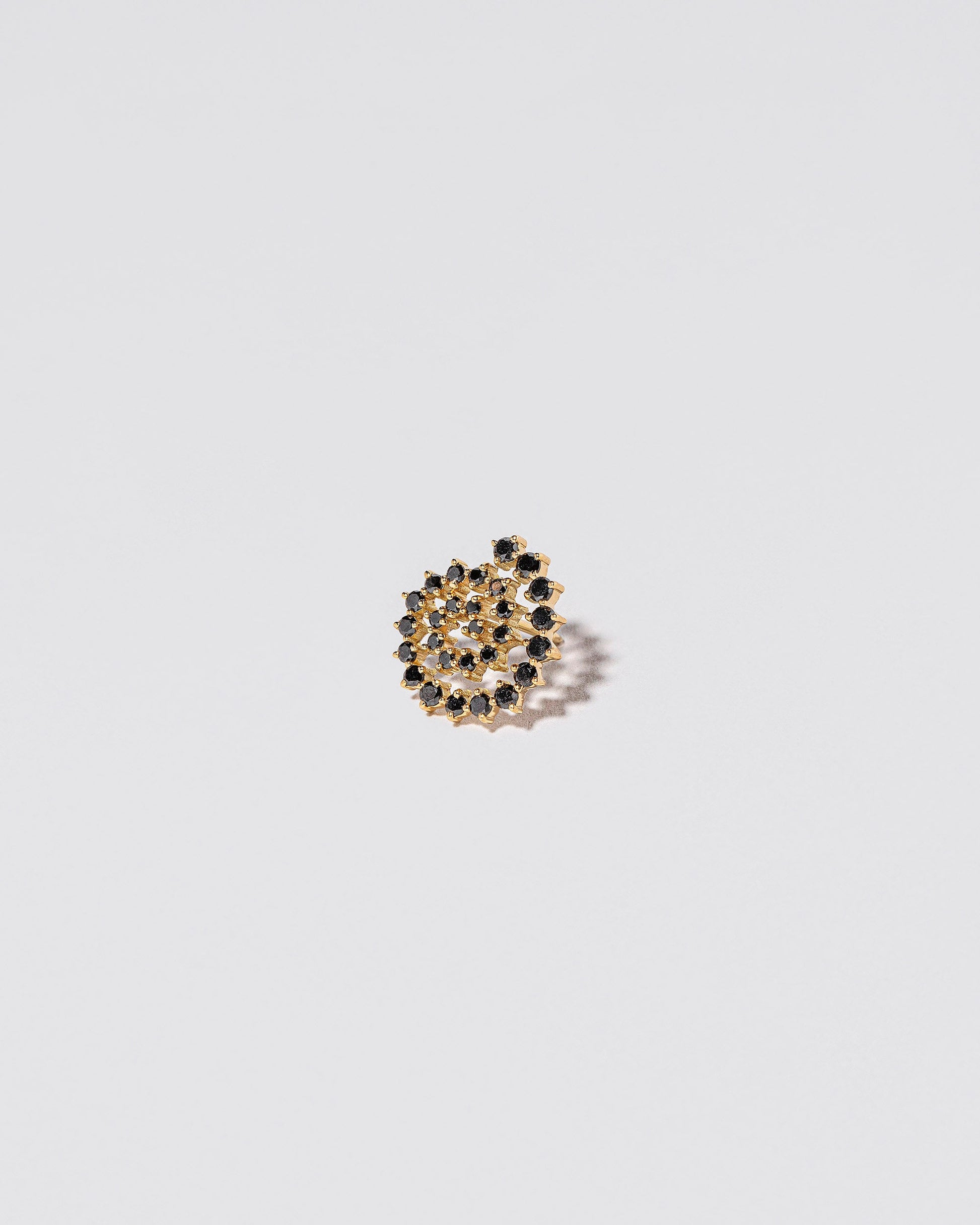 Spiral Earring Single Stud on light colored background.