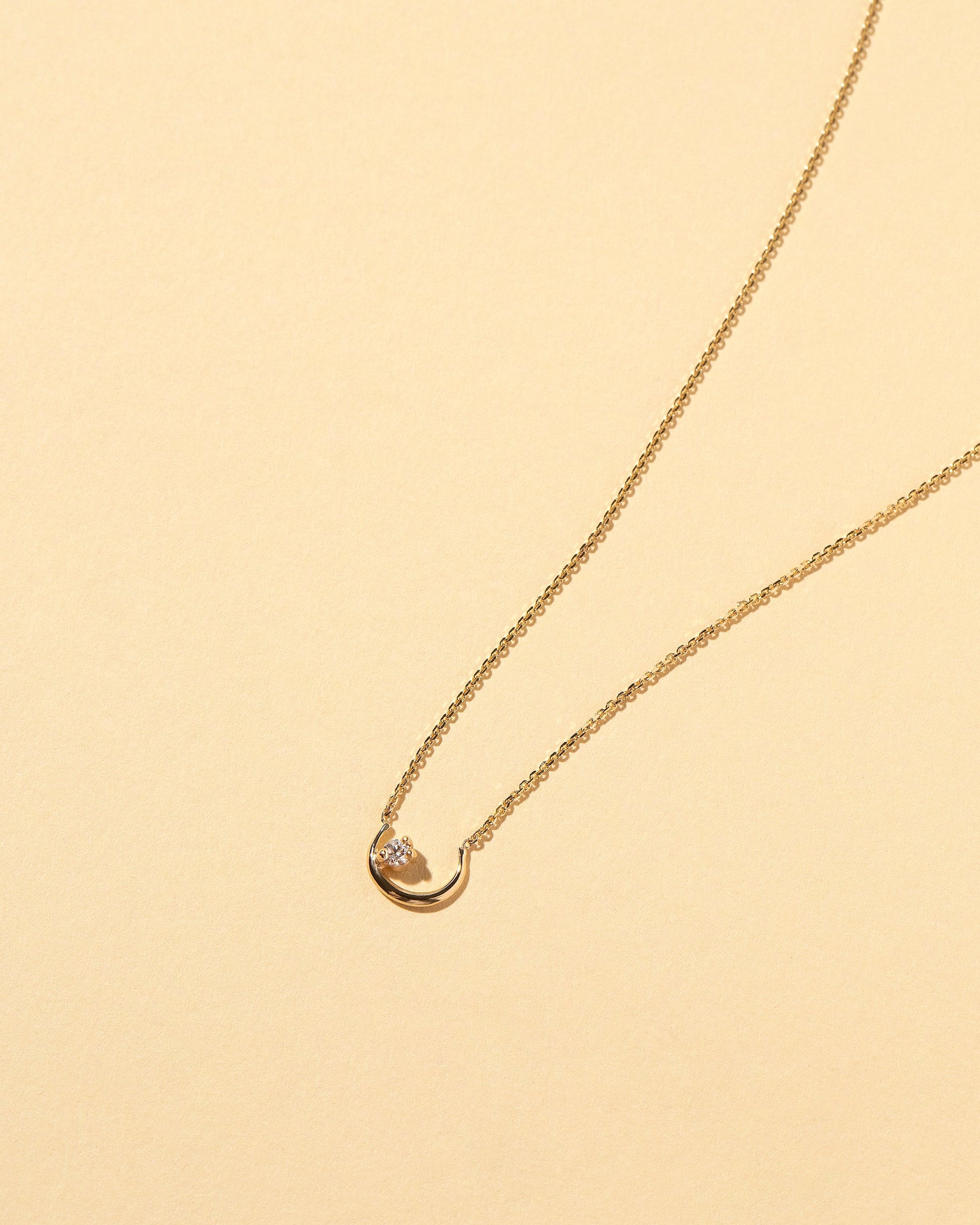 Moon Ray Necklace on light color background.