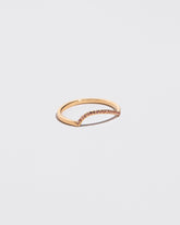Gold Pavé Peach Sapphire Left Slump Band on light color background.