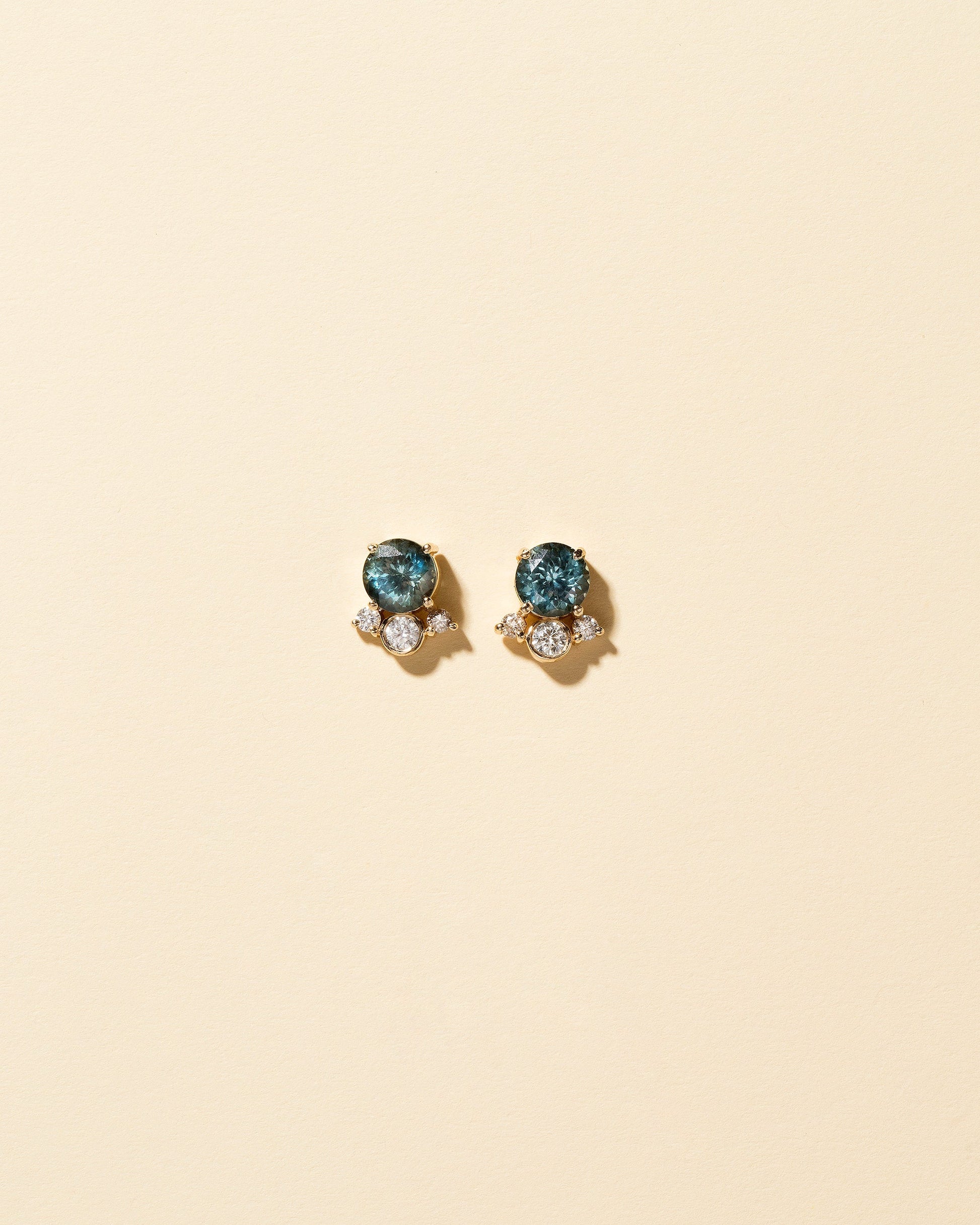Vega Earrings - Blue Sapphire on light color background.
