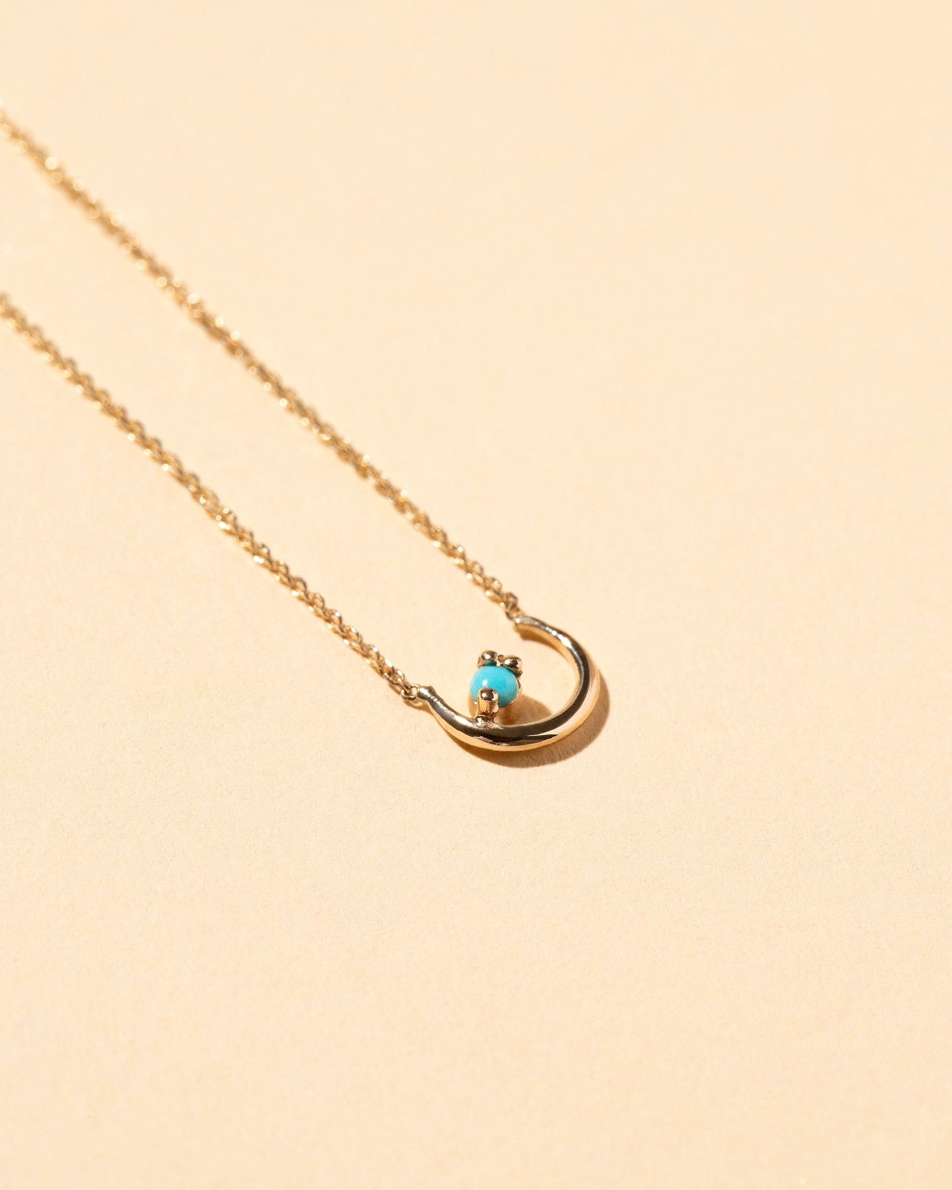 Moon Ray Necklace on light color background.