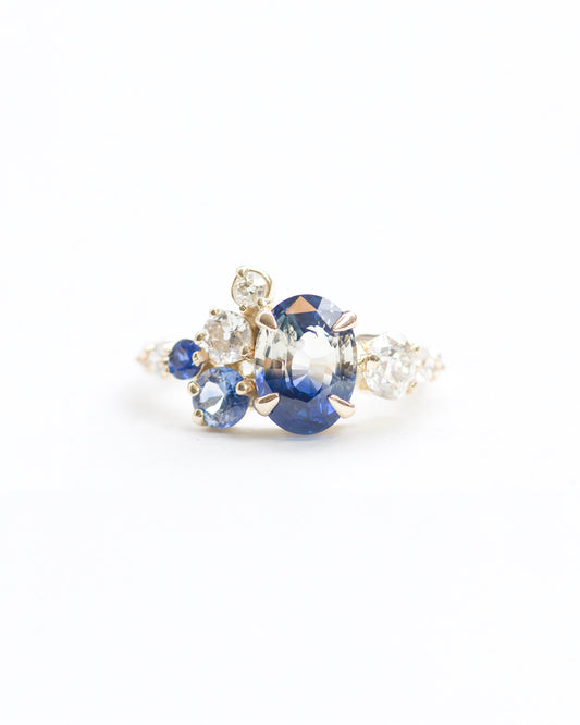Blue and white bicolor sapphire and white diamond stone cluster ring front view