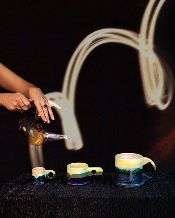 Styled long exposure image featuring the Ornamental by Lameice Amber & Lilac Dream Teapot and the limited edition Echo Park by Peter Shire mugs  on dark color background.