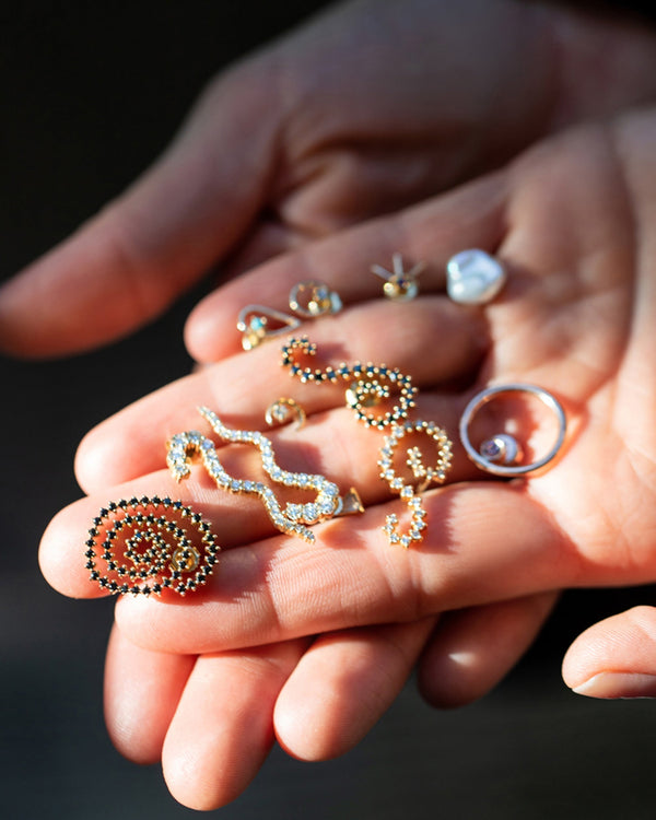 Mociun fine jewelry in hand.