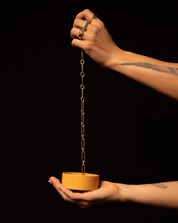 Model holding Link Necklace and Mociun jewelry box.