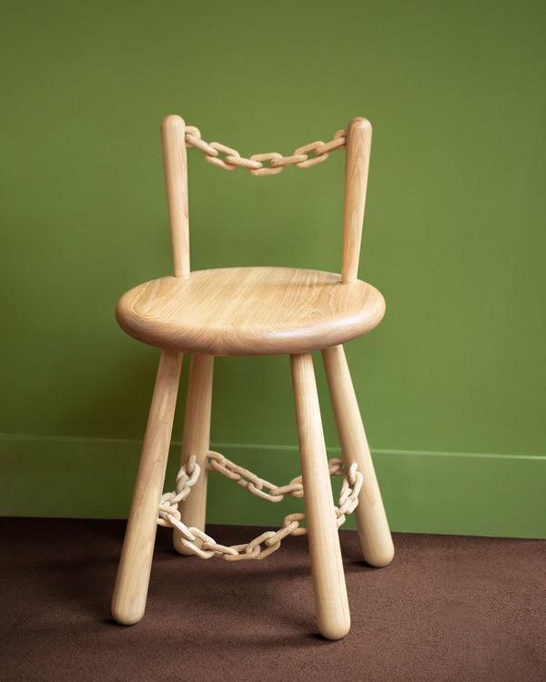 Pat Kim Chain Chair One on green color background.