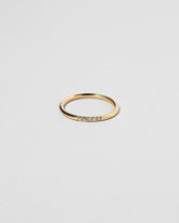 Gold Five Stone Blue Sapphire Dot Band on light color background.