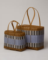 Group of Palorosa Tobacco & Blue Lilac Small and Medium Handwoven Mercado Basket Bags on light color background.