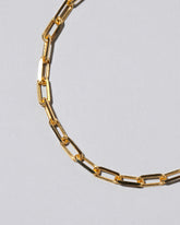 Closeup detail of the Lightweight Beveled Oval Chain Bracelet on light color background.