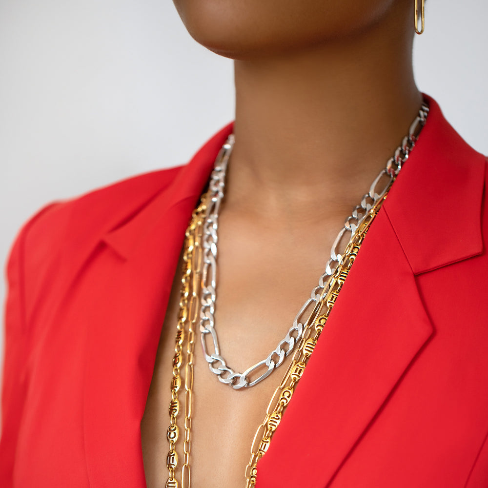 product_details::Silver Figaro Chain, Long Loop Chain Necklace and Jean Paris Zodiac Anchor Chain Necklace on model.