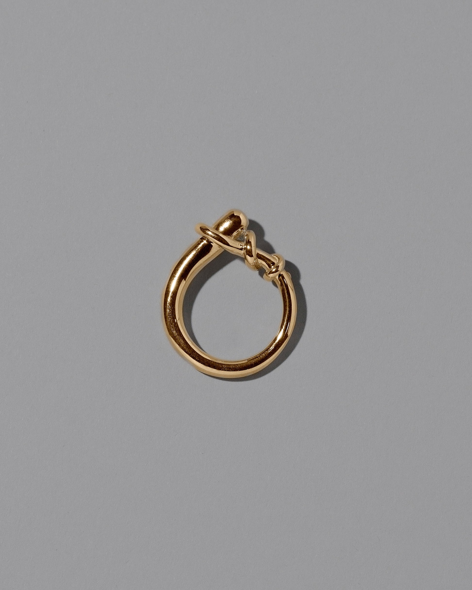 View from the side the of the CRZM Gold Terrane Ring on light color background.