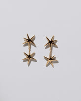 Verve Star Drop Earrings on light color background.