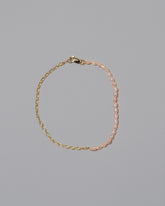 Half Oval Chain & Peony Seed Pearl Bracelet on light color background.