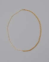 Half Short Loop Chain & White Seed Pearl Necklace on light color background.