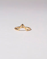 Gold Single Burnish-Set Black Diamond Triangle Band on light color background.